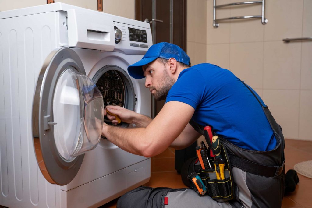 a technician repairing a washer and dryer repair charlotte